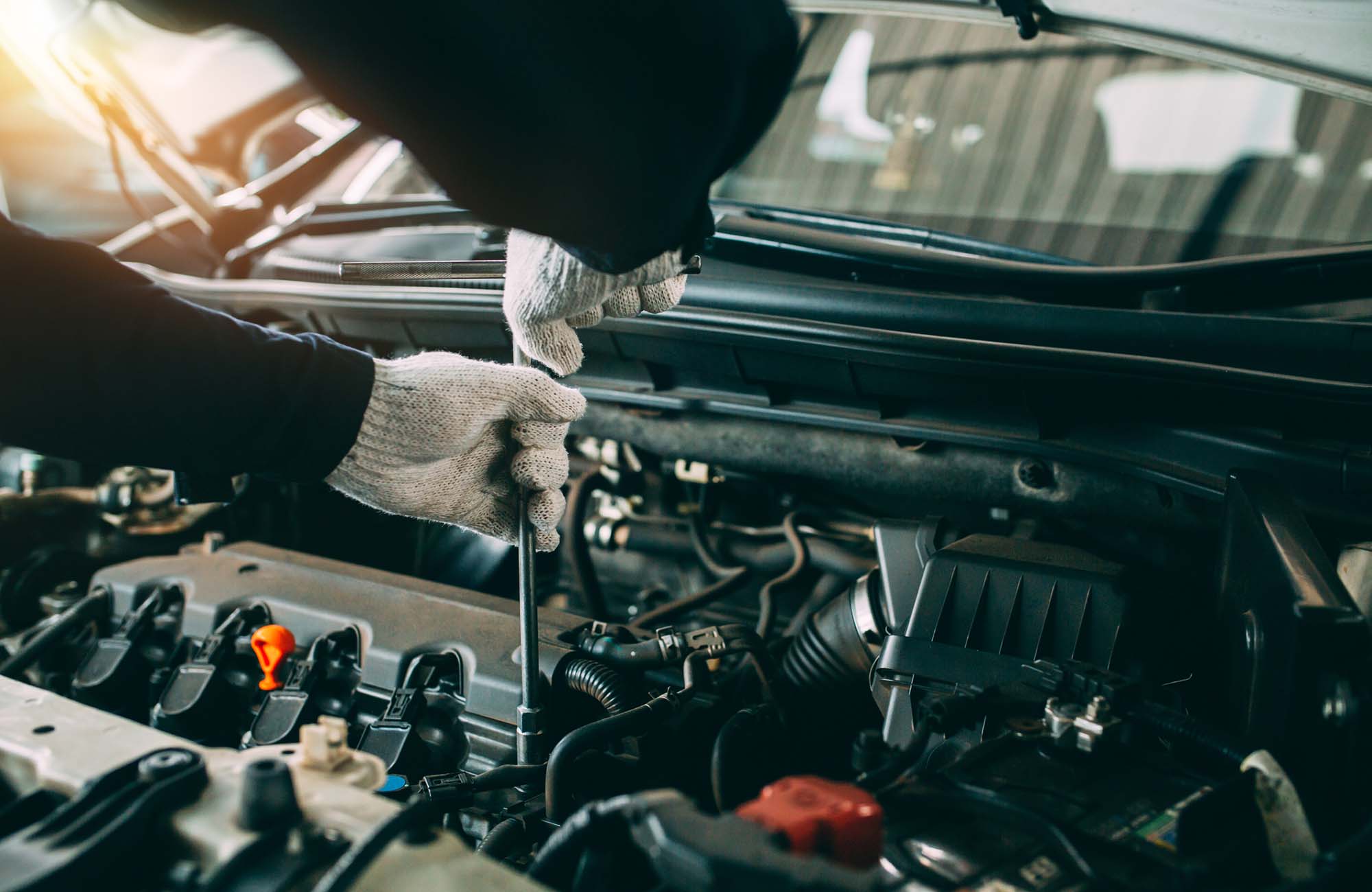 Car Repair service, Auto mechanic working in garage, Mechanic hands checking up of serviceability of the car in open hood, close up.