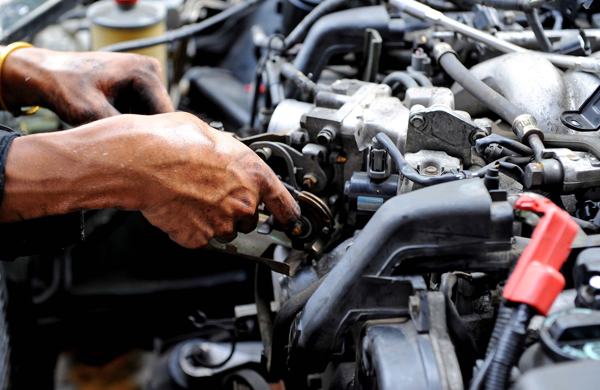 Repair of the engine. A hand with the tool. Automo